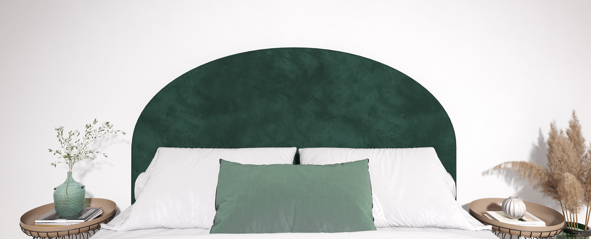 Rounded Emerald headboard behind a bed